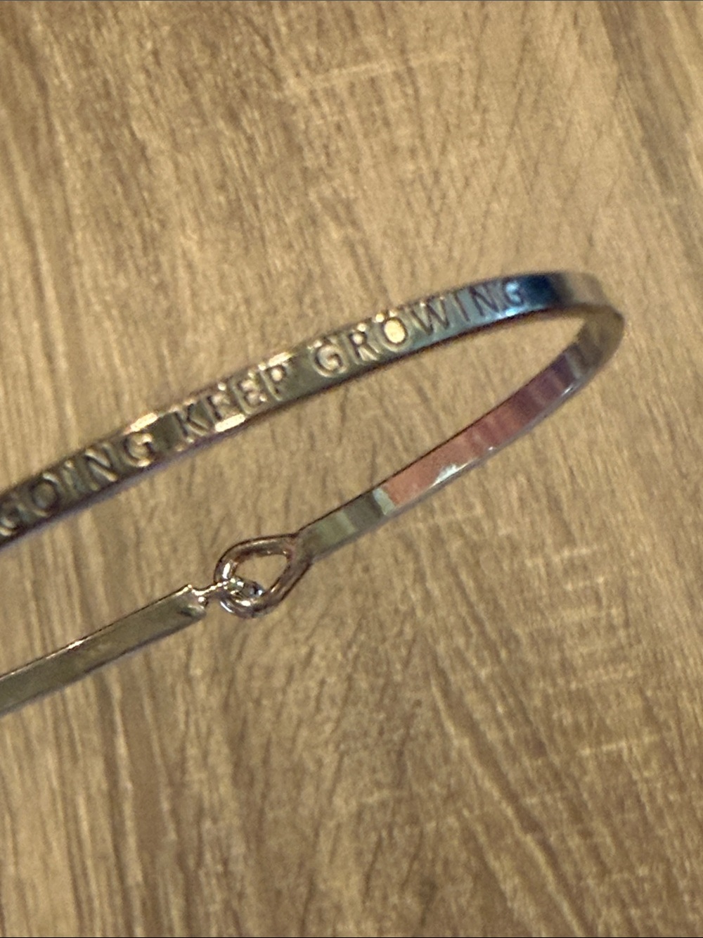 Thin Silver Bracelet says “Never Give Up Keep Going Keep Growing”